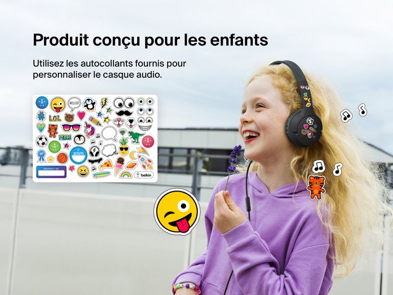 Smiling girl wearing Belkin Wired On-Ear Headphones for Kids decorated with colorful stickers, highlighting the headset’s personalization feature with included fun sticker sheet.