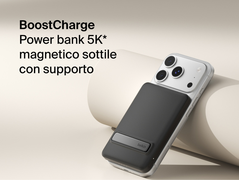 Belkin BoostCharge Slim Magnetic Power Bank 5K with Qi2 wirelessly attached to a smartphone, featuring a slim magnetic design with integrated card storage for portable on-the-go charging.