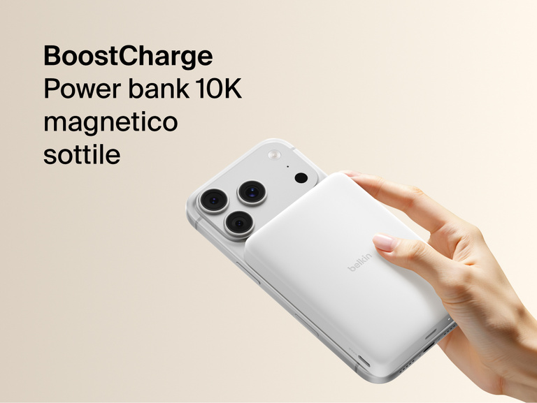 Belkin BoostCharge Slim Magnetic Power Bank 10K magnetically attached to iPhone, demonstrating secure wireless charging with a slim portable design