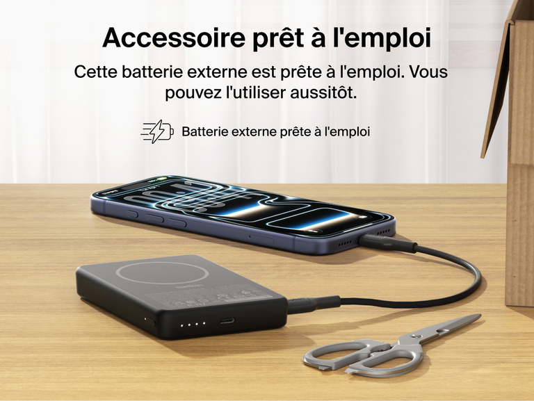 Belkin BoostCharge Slim Magnetic Power Bank 10K precharged out of the box powering a smartphone via USB-C cable with portable battery placed on a desk