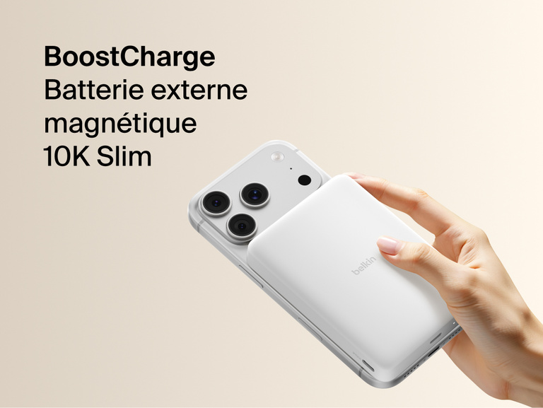 Belkin BoostCharge Slim Magnetic Power Bank 10K magnetically attached to iPhone, demonstrating secure wireless charging with a slim portable design