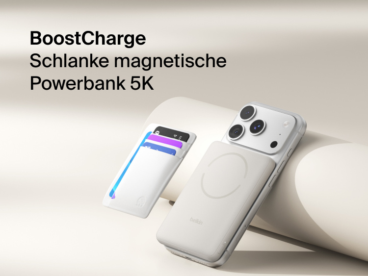 Belkin BoostCharge Slim Magnetic Power Bank 5K with Qi2 wirelessly attached to a smartphone, featuring a slim magnetic design with integrated card storage for portable on-the-go charging.
