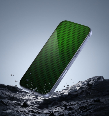 Smartphone with a glowing green protective screen surface rising from a rugged rocky landscape, symbolizing durability and advanced screen protection.