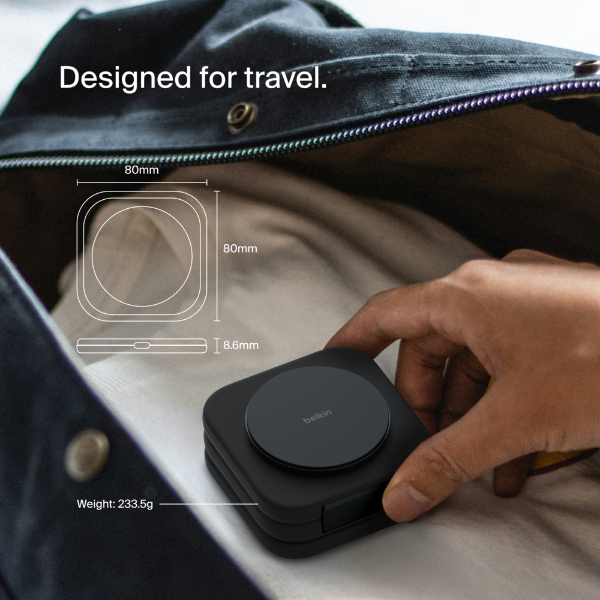 This image showcases a compact and portable wireless charger designed for travel. A hand is seen placing the sleek black device into a travel bag, emphasizing its convenience and portability. Technical specifications are overlayed on the image, showing dimensions of 80mm x 80mm x 18.6mm and a weight of 233.5g. The text "Designed for travel" highlights its compact design, making it ideal for on-the-go charging needs. The device's minimalist design blends functionality with a modern aesthetic.