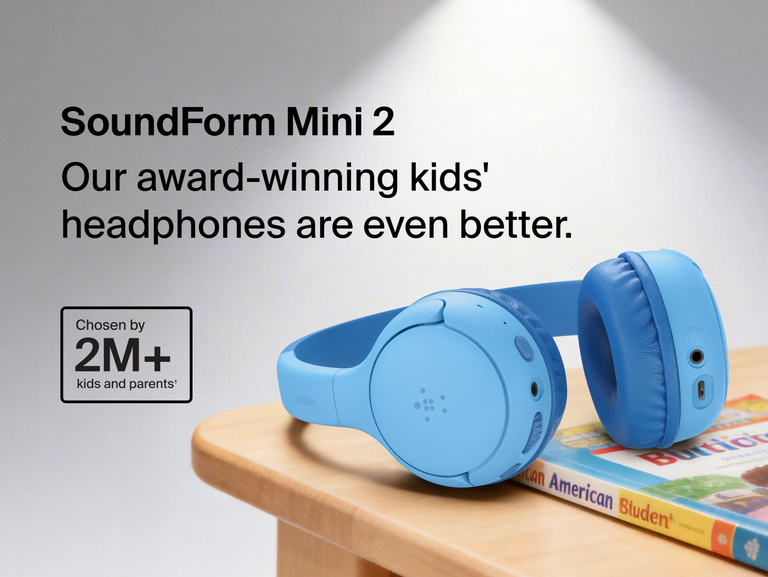 SoundForm Mini 2 Wireless On-Ear Headphones for Kids resting on a wooden surface beside a children's book, with on-image text reading Our award-winning kids' headphones are even better and Chosen by 2M+ kids and parents