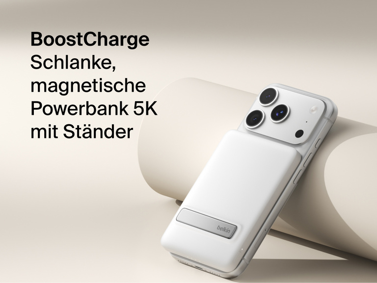 Belkin BoostCharge Slim Magnetic Power Bank 5K with Qi2 wirelessly attached to a smartphone, featuring a slim magnetic design with integrated card storage for portable on-the-go charging.