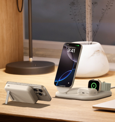 Belkin 3-in-1 Magnetic Foldable Wireless Charger and Magnetic Power Bank Bundle shown charging iPhone, Apple Watch, and AirPods on a wooden desk for convenient all-in-one power.