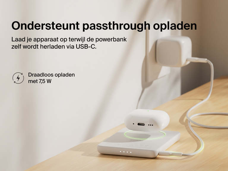 Belkin BoostCharge Slim Magnetic Power Bank 5K shown wirelessly charging earbuds while recharging via USB-C, demonstrating 7.5W pass-through charging functionality.