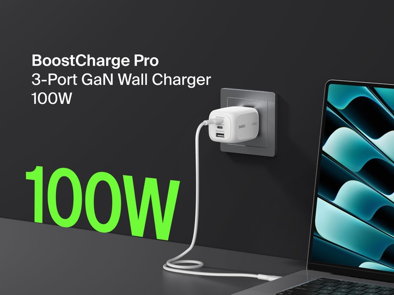BoostCharge Pro 3-Port GaN Wall Charger 100W plugged into a wall outlet, fast charging a laptop with bold green “100W” text highlighting its powerful output.
