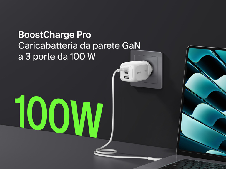BoostCharge Pro 3-Port GaN Wall Charger 100W plugged into a wall outlet, fast charging a laptop with bold green “100W” text highlighting its powerful output.