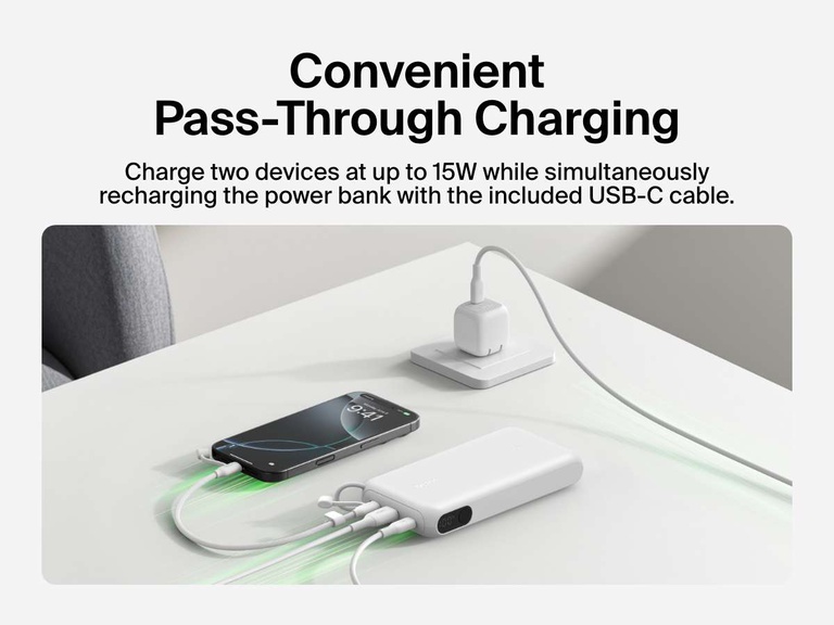 Belkin BoostCharge Power Bank 20K with Display shown using pass-through charging to power two devices at up to 15W while recharging the power bank via the included USB-C cable.