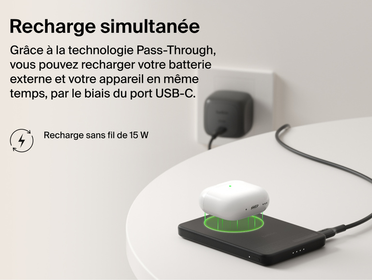 Belkin BoostCharge Slim Magnetic Power Bank 5K with Qi2 demonstrating pass-through charging, wirelessly powering a device while the power bank recharges via USB-C.