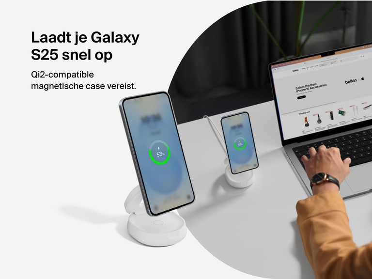 Belkin BoostCharge 2-in-1 Convertible Magnetic Charging Stand with Qi2 15W shown fast charging a Galaxy S25 in a Qi2-compatible magnetic case at a desktop workspace.