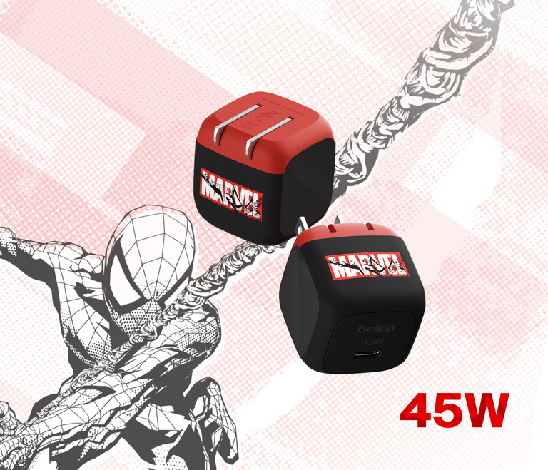 A Belkin BoostCharge Compact USB-C Wall Charger 45W is plugged into a wall socket on a wooden surface, charging a connected laptop, with "45W" displayed in bold text.