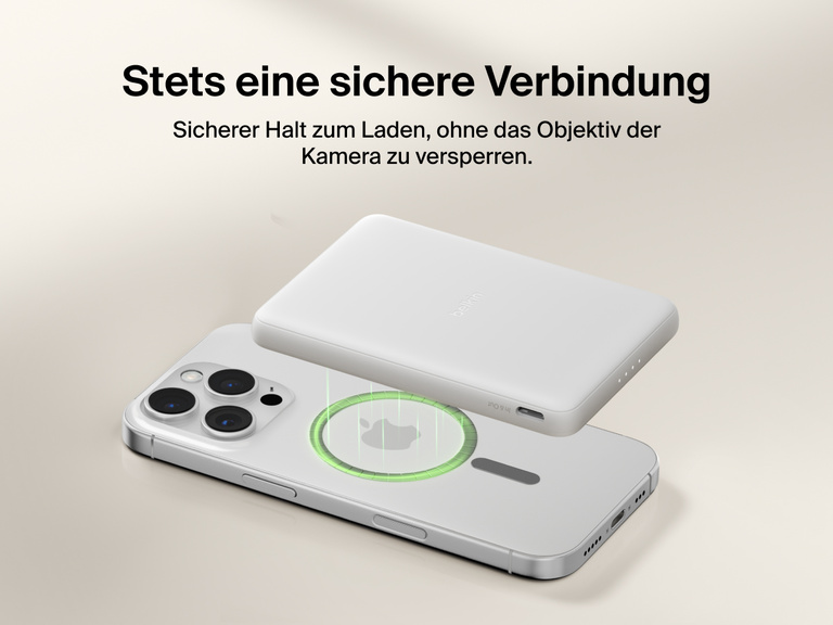Belkin BoostCharge Slim Magnetic Power Bank 5K shown magnetically aligned between a smartphone and wallet accessory, demonstrating precise magnetic ring for secure attachment and camera-safe design.
