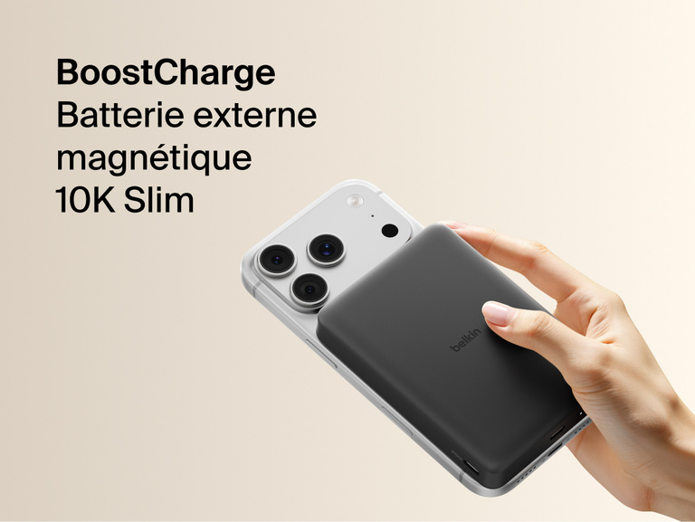 Belkin BoostCharge Slim Magnetic Power Bank 10K magnetically attached to iPhone, demonstrating secure wireless charging with a slim portable design