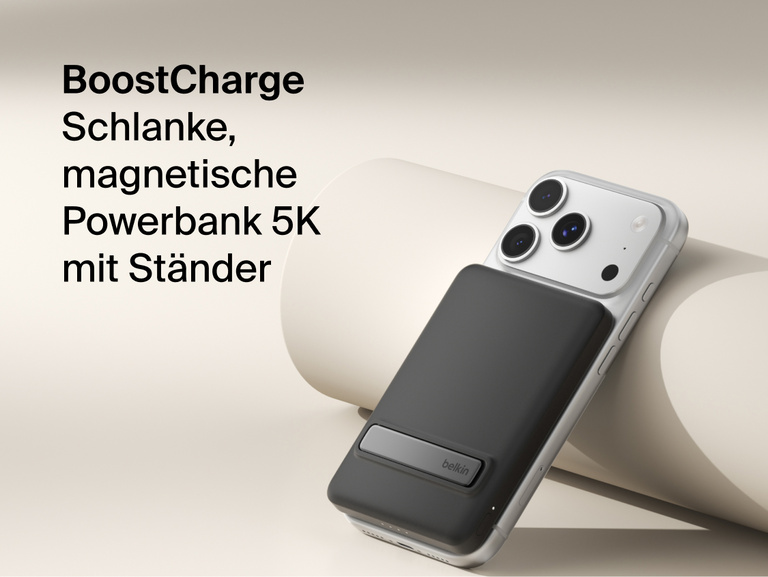 Belkin BoostCharge Slim Magnetic Power Bank 5K with Qi2 wirelessly attached to a smartphone, featuring a slim magnetic design with integrated card storage for portable on-the-go charging.