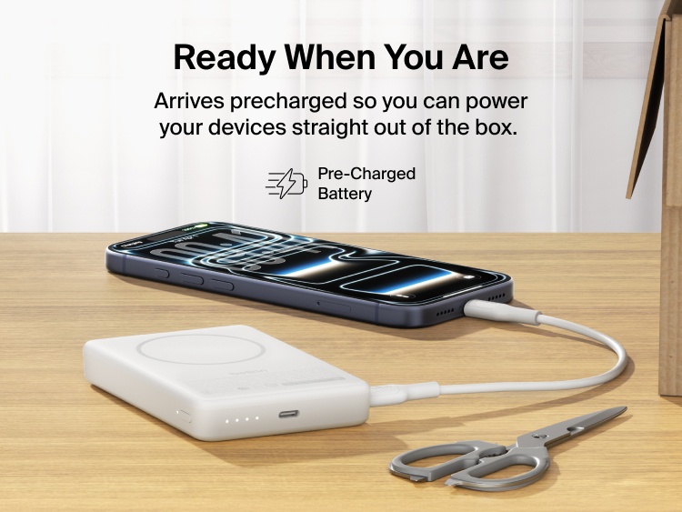 Slim Magnetic Power Bank 10K with Qi2 charging smartphone on desk with precharged battery indicator lights visible