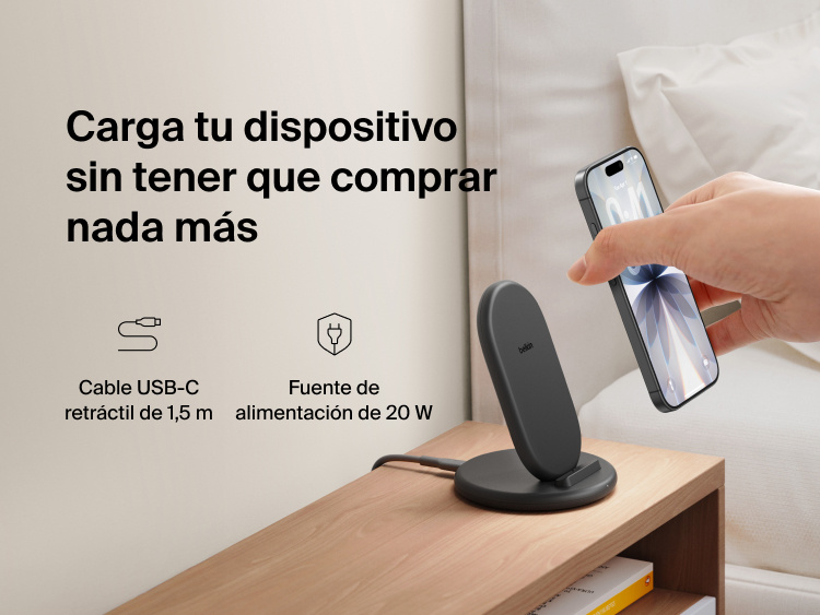 Belkin BoostCharge Wireless Charging Stand 15W shown on a bedside table with smartphone, includes 5ft USB-C cable and 20W power adapter for immediate charging out of the box.