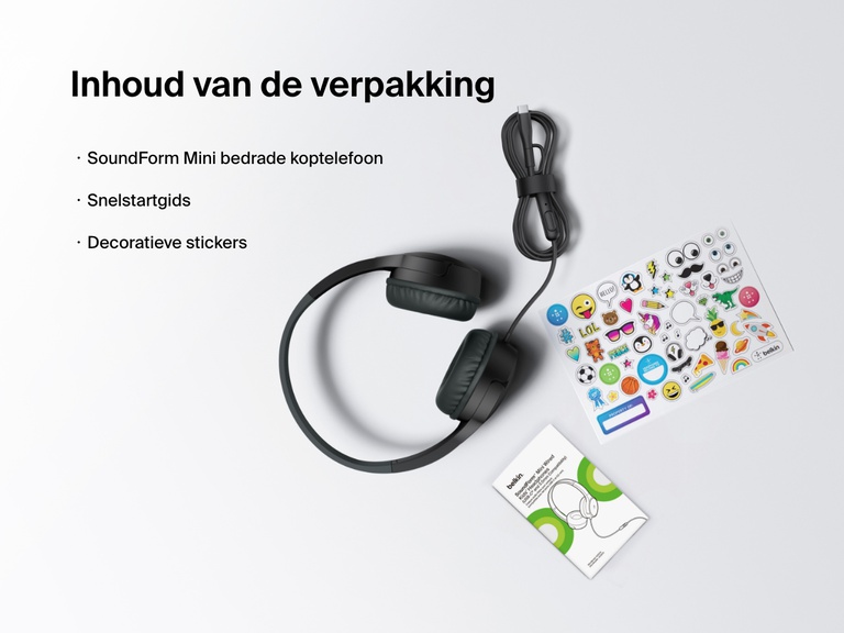 Flat lay image showing the contents of the Belkin SoundForm Mini Wired Headphones box, including the headphones, a quick start guide, and a sheet of decorative stickers.