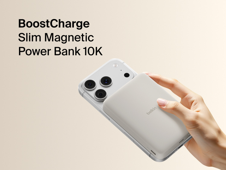 Belkin BoostCharge Slim Magnetic Power Bank 10K magnetically attached to iPhone, demonstrating secure wireless charging with a slim portable design