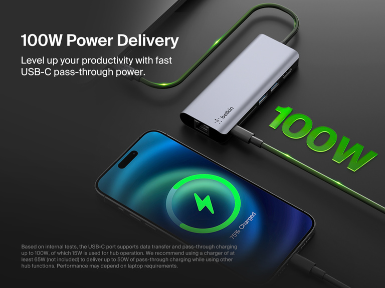 A Belkin Connect USB-C 6-in-1 Multiport Hub is shown charging a smartphone via USB-C pass-through power, highlighting its 100W power delivery capability with glowing green accents emphasizing fast charging efficiency.