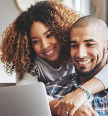 Couple looking at their laptop