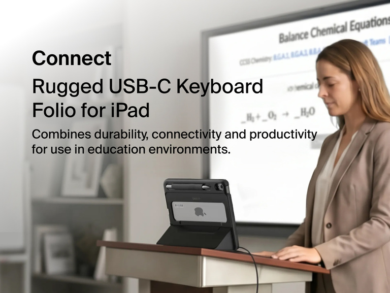 USB-C Keyboard Folio with Display Hub for iPad used by a teacher at a podium with an external classroom display.