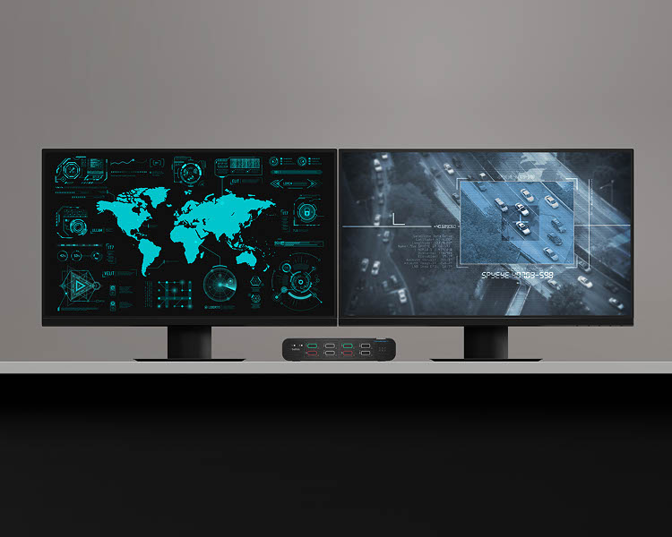 Dual monitors displaying data analytics and surveillance imagery, connected via the Belkin Universal DisplayPort DuoClave Secure KVM Series, facilitating secure and efficient multi-system management.