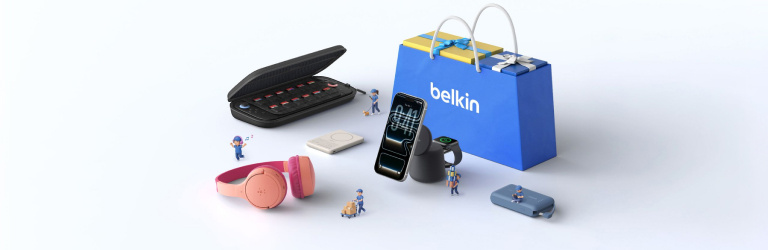 Belkin tech accessories including wireless chargers, headphones, and portable power solutions arranged around a branded shopping bag, highlighting everyday charging essentials and mobile connectivity.