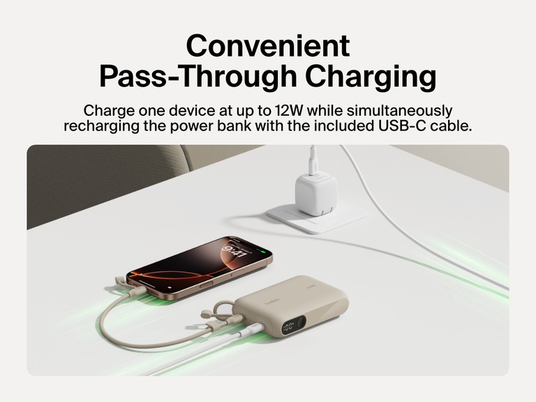 Belkin BoostCharge Power Bank 10K with Display shown delivering pass-through charging, powering a smartphone at up to 12W while recharging via the included USB-C cable.