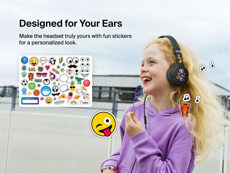 Smiling girl wearing Belkin Wired On-Ear Headphones for Kids decorated with colorful stickers, highlighting the headset’s personalization feature with included fun sticker sheet.