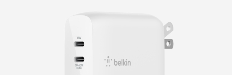 Close-up image of a Belkin GaN charger with two USB-C ports and foldable prongs.