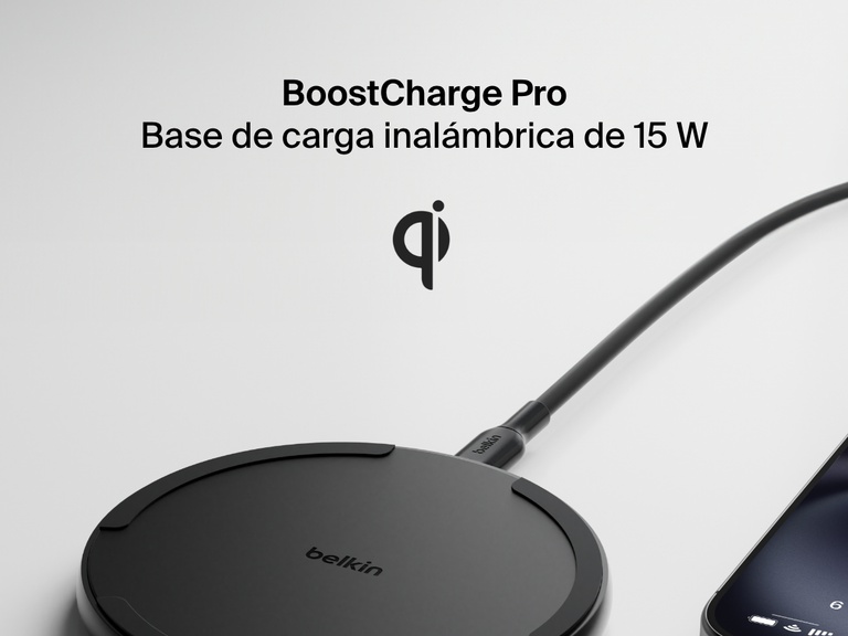 A black Belkin BoostCharge Pro Wireless Charging Pad 15W is shown in black with a connected charging cable, partially visible smartphone, and a Qi logo above the product name on a light background.