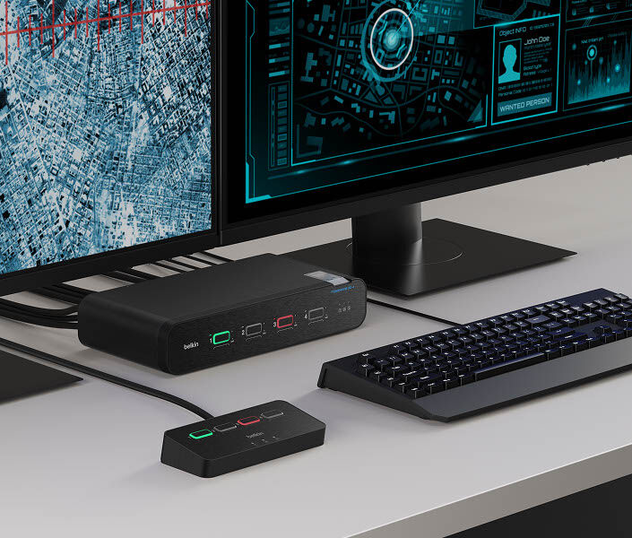 A Belkin Universal DisplayPort Secure KVM setup on a desk, connected to dual monitors, a keyboard, and an external switch for secure and efficient switching between two computer systems.
