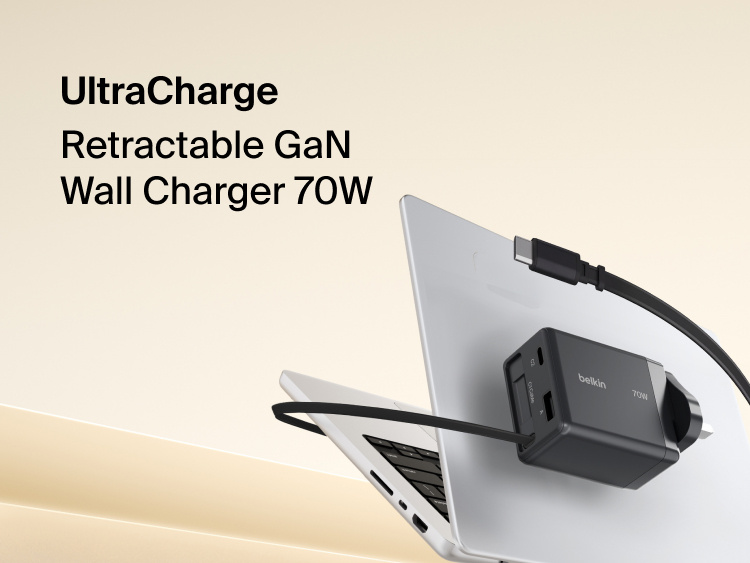 BoostCharge Pro 3-Port GaN Wall Charger 100W plugged into a wall outlet, fast charging a laptop with bold green &ldquo;100W&rdquo; text highlighting its powerful output.