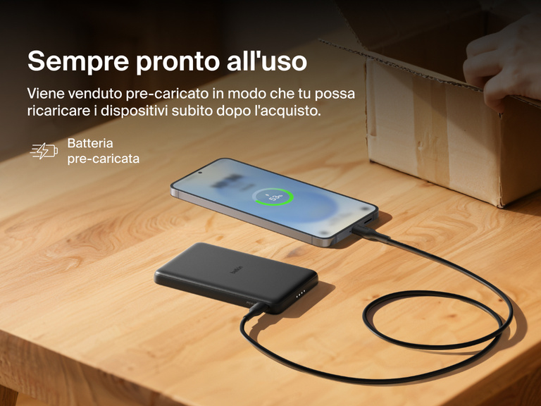 Belkin BoostCharge Slim Magnetic Power Bank 5K shown charging a smartphone on a table, highlighting its precharged battery ready for instant use out of the box.