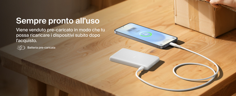 Belkin BoostCharge Slim Magnetic Power Bank 5K shown charging a smartphone on a table, highlighting its precharged battery ready for instant use out of the box.