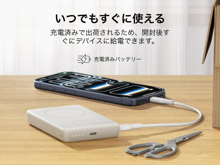 Slim Magnetic Power Bank 10K with Qi2 charging smartphone on desk with precharged battery indicator lights visible