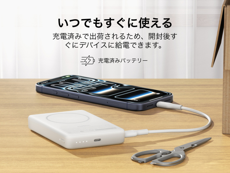 Slim Magnetic Power Bank 10K with Qi2 charging smartphone on desk with precharged battery indicator lights visible