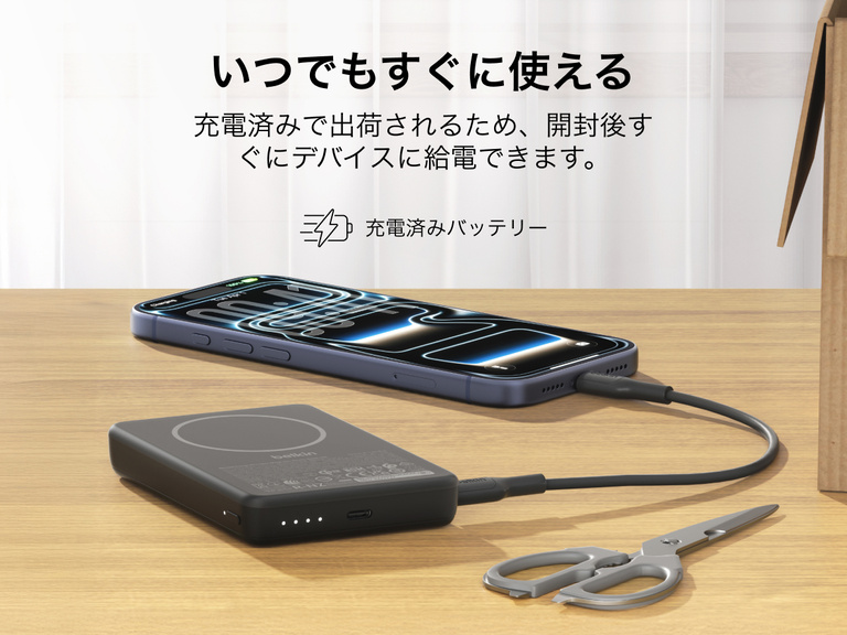 Slim Magnetic Power Bank 10K with Qi2 charging smartphone on desk with LED battery indicators and precharged readiness