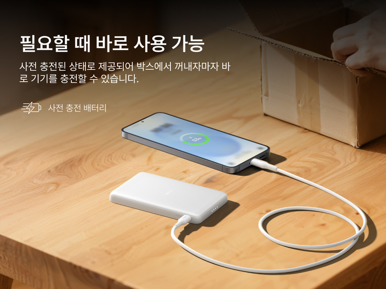Belkin BoostCharge Slim Magnetic Power Bank 5K shown charging a smartphone on a table, highlighting its precharged battery ready for instant use out of the box.