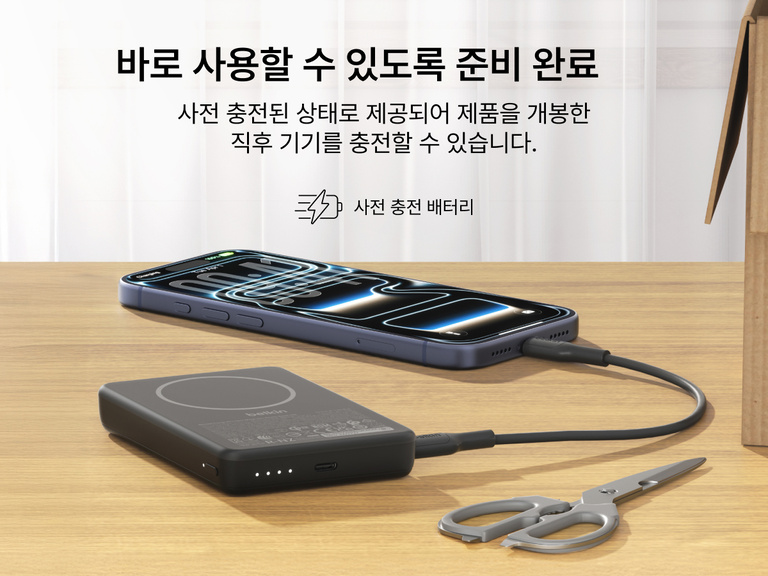 Slim Magnetic Power Bank 10K with Qi2 charging smartphone on desk with LED battery indicators and precharged readiness