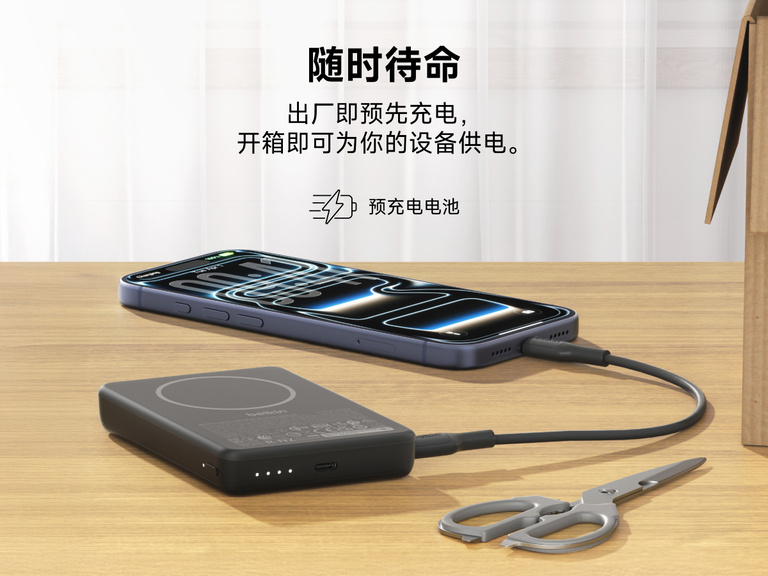 Slim Magnetic Power Bank 10K with Qi2 charging smartphone on desk with LED battery indicators and precharged readiness