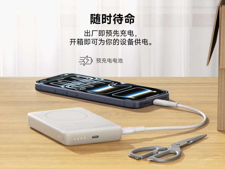 Slim Magnetic Power Bank 10K with Qi2 charging smartphone on desk with precharged battery indicator lights visible
