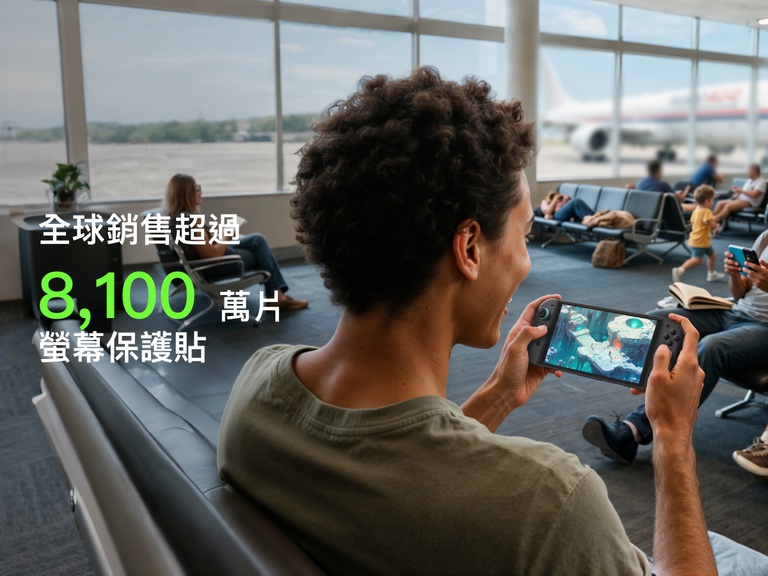 A young person smiles while playing a game on a Nintendo Switch 2 at an airport gate area. In the background, other travelers are seated, reading or using their phones, and a plane is visible through the window. Large green text in the foreground reads &ldquo;81M+,&rdquo; and white text below states &ldquo;Screen Protectors Sold,&rdquo; highlighting the popularity of the product.