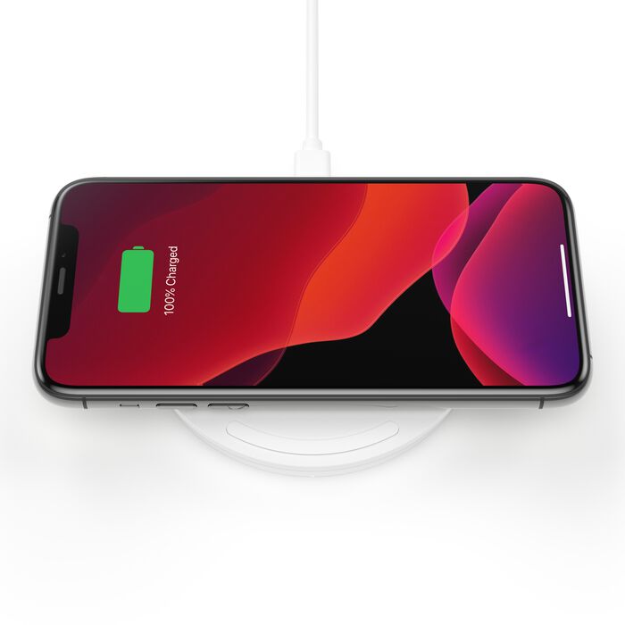 Belkin BoostCharge 10W Wireless Charging Pad in white with a smartphone
