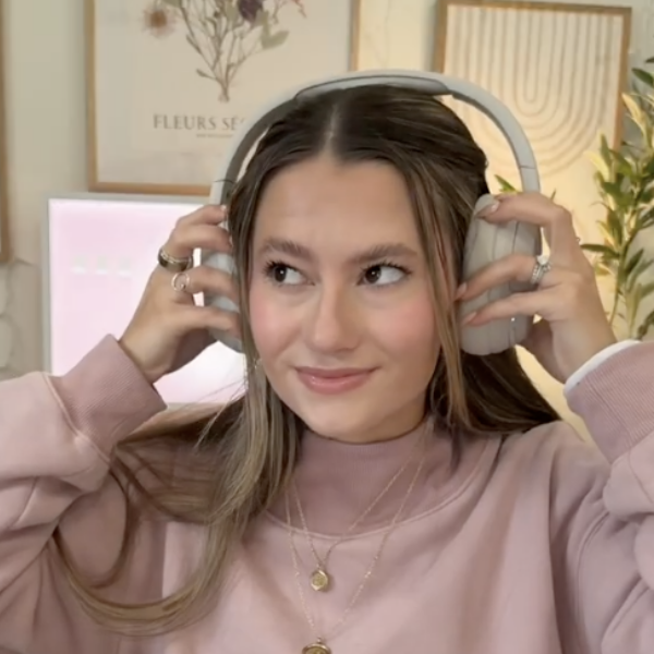 Julia Bartrom is showing the SoundForm Isolate headphones.