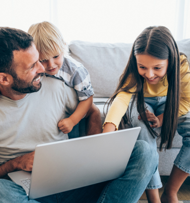 Father and kids shopping on a laptop