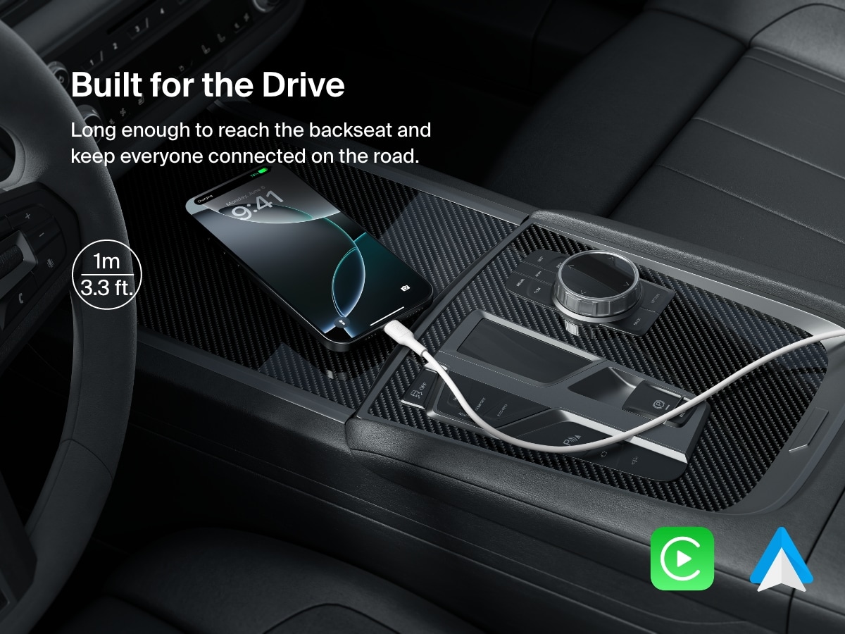 A 1-meter (3.3 ft) Belkin BoostCharge USB-A to USB-C Cable 15W charges a smartphone in a car, offering ample length for backseat access and compatibility with Apple CarPlay and Android Auto.